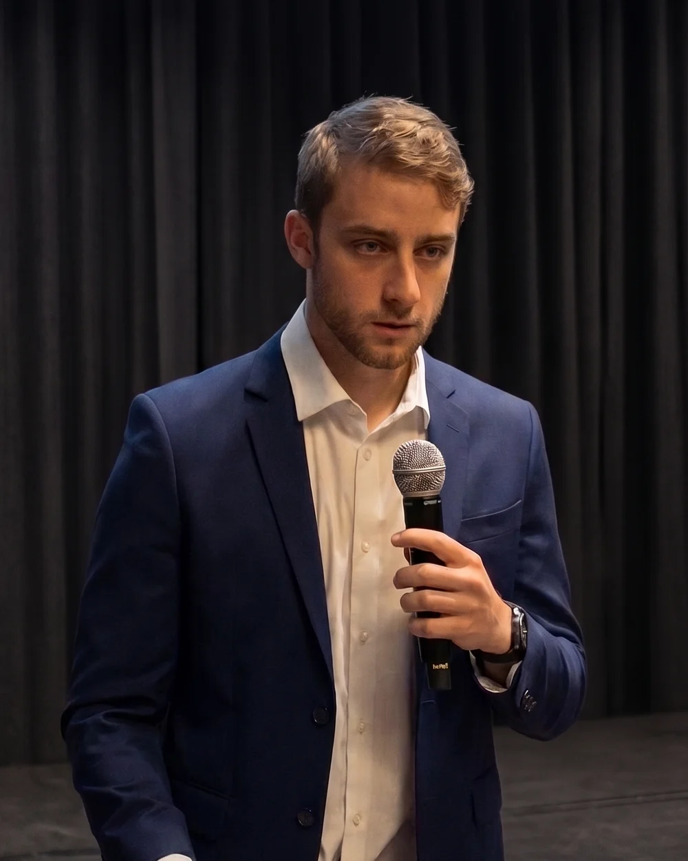 Alex Moussalli, founder of AAMM Group, speaking with a microphone at an event